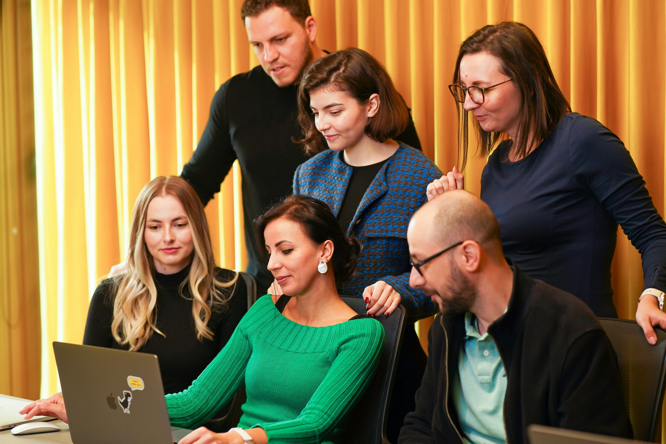Members of a marketing firm in West Virginia looking at a laptop