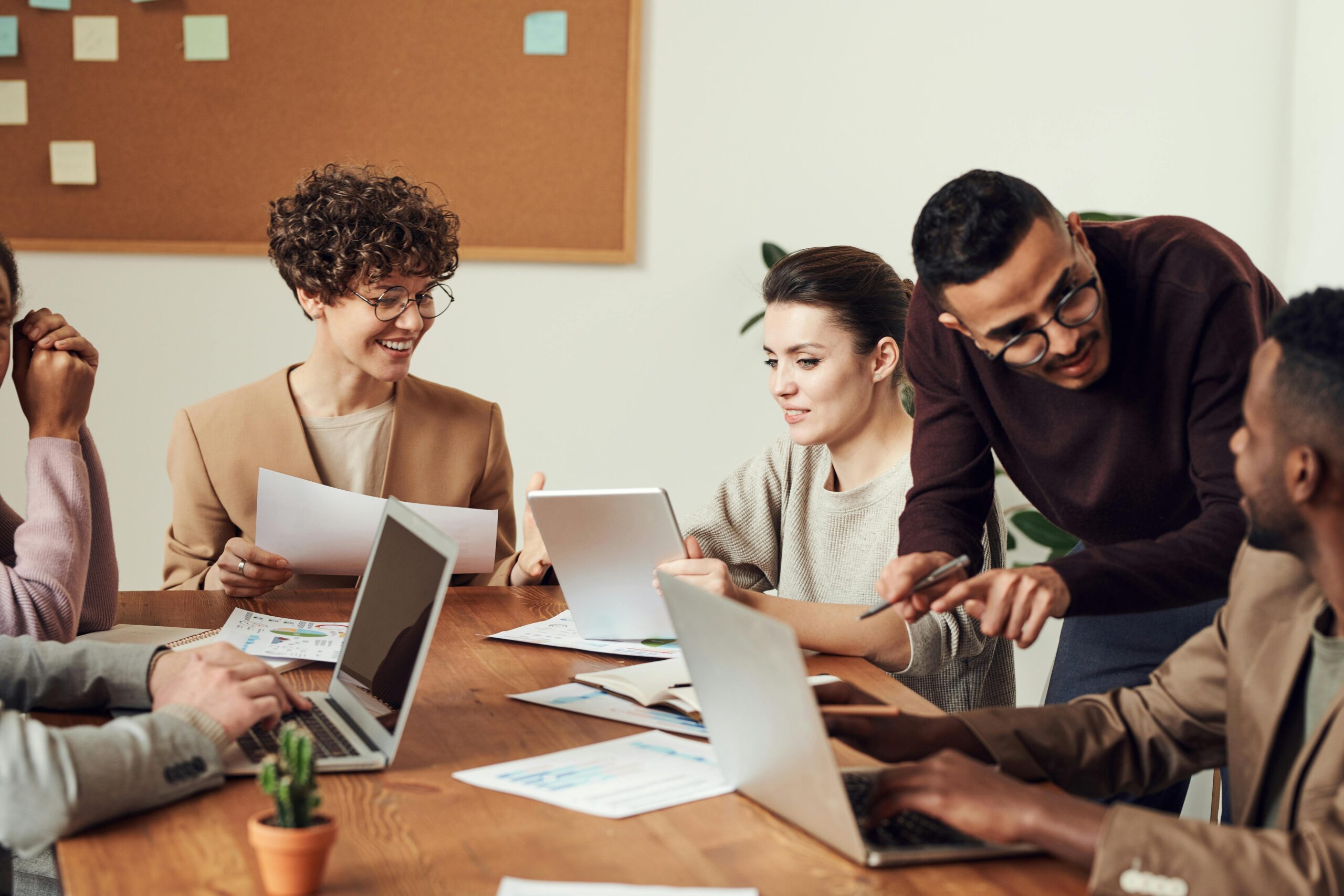 A group of employees gathered around a wooden table.